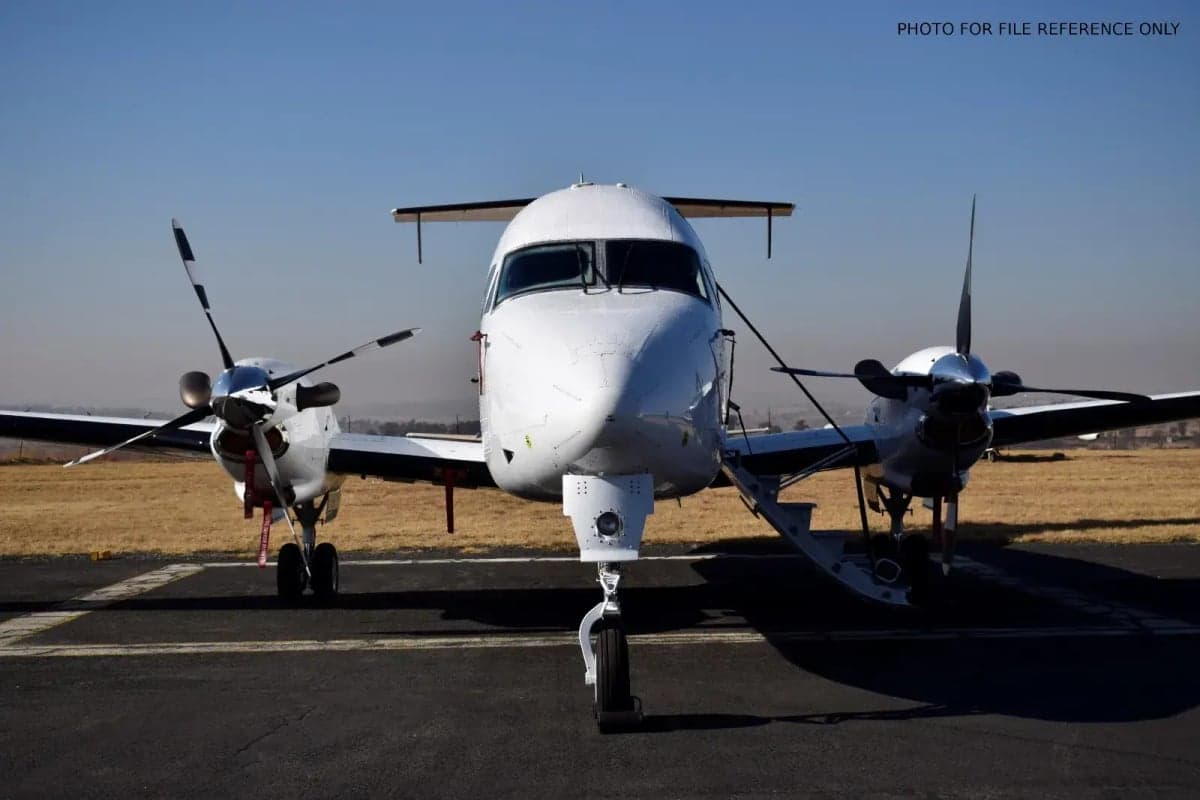 Front view of a white turboprop aircraft on the tarmac.