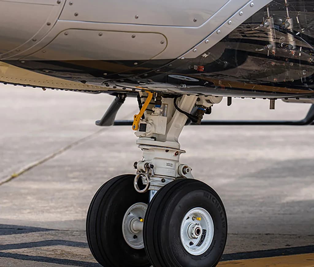 Close-up view of the AgustaWestland AW169 helicopter's main landing gear with two wheels.