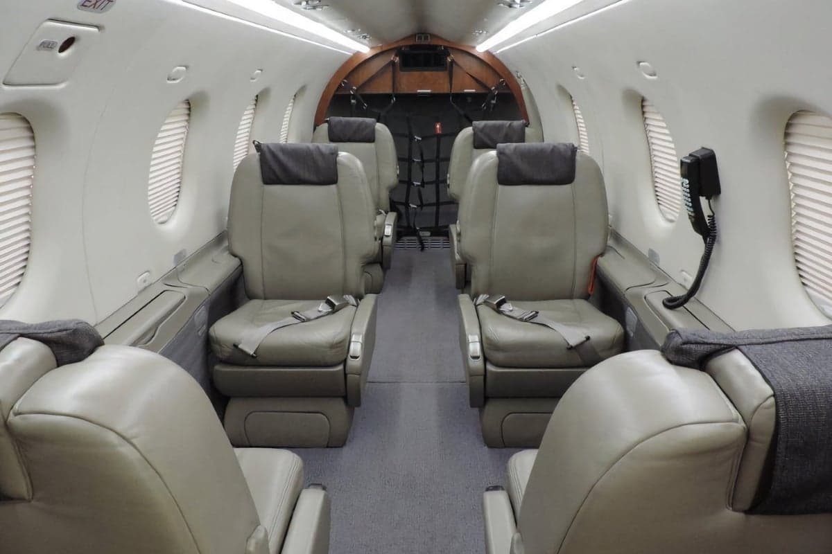 View of the aircraft's interior cabin with beige leather seats.