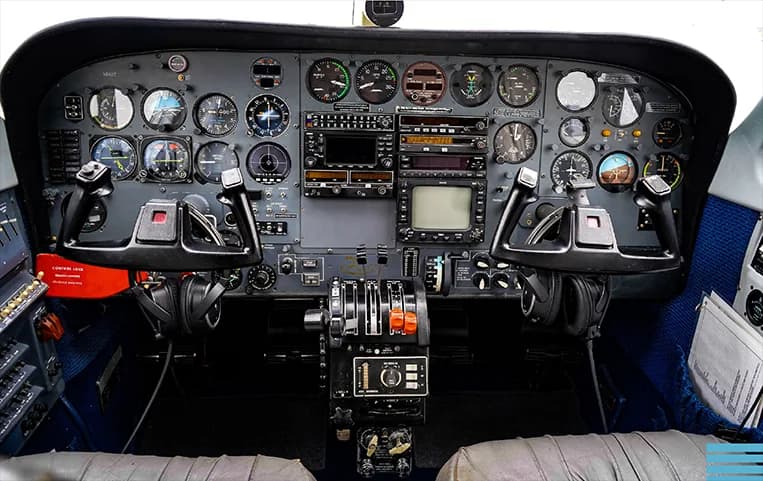 The cockpit of a Piper PA-34 Seneca aircraft, showing the instrument panel and controls.