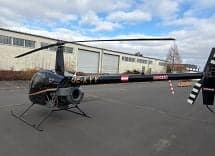 Robinson R44 helicopter OE-XYY parked on the tarmac.