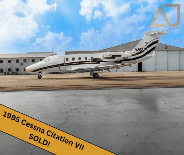 A 1995 Cessna Citation VII, tail number N202JP, parked on the tarmac.