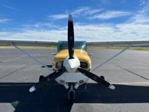 A close-up of the front of a Cessna 182RG on the tarmac.