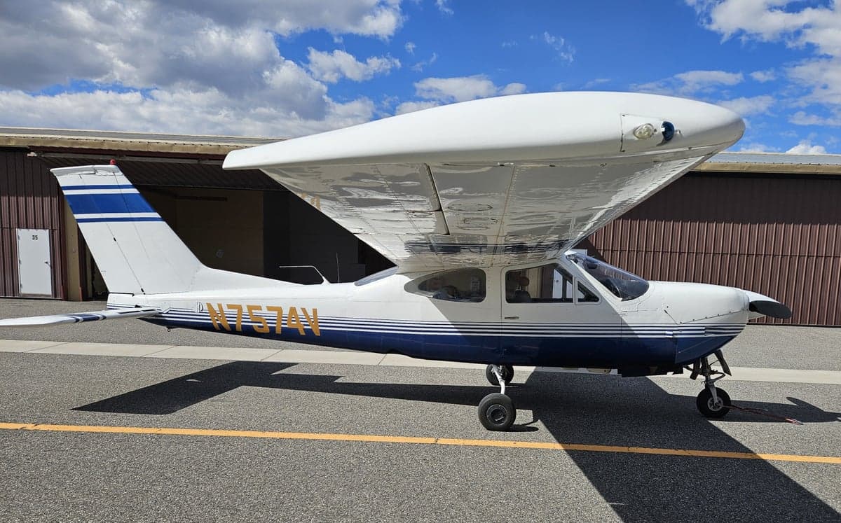 A Cessna 182 Skylane, tail number N7574V, parked on the tarmac.