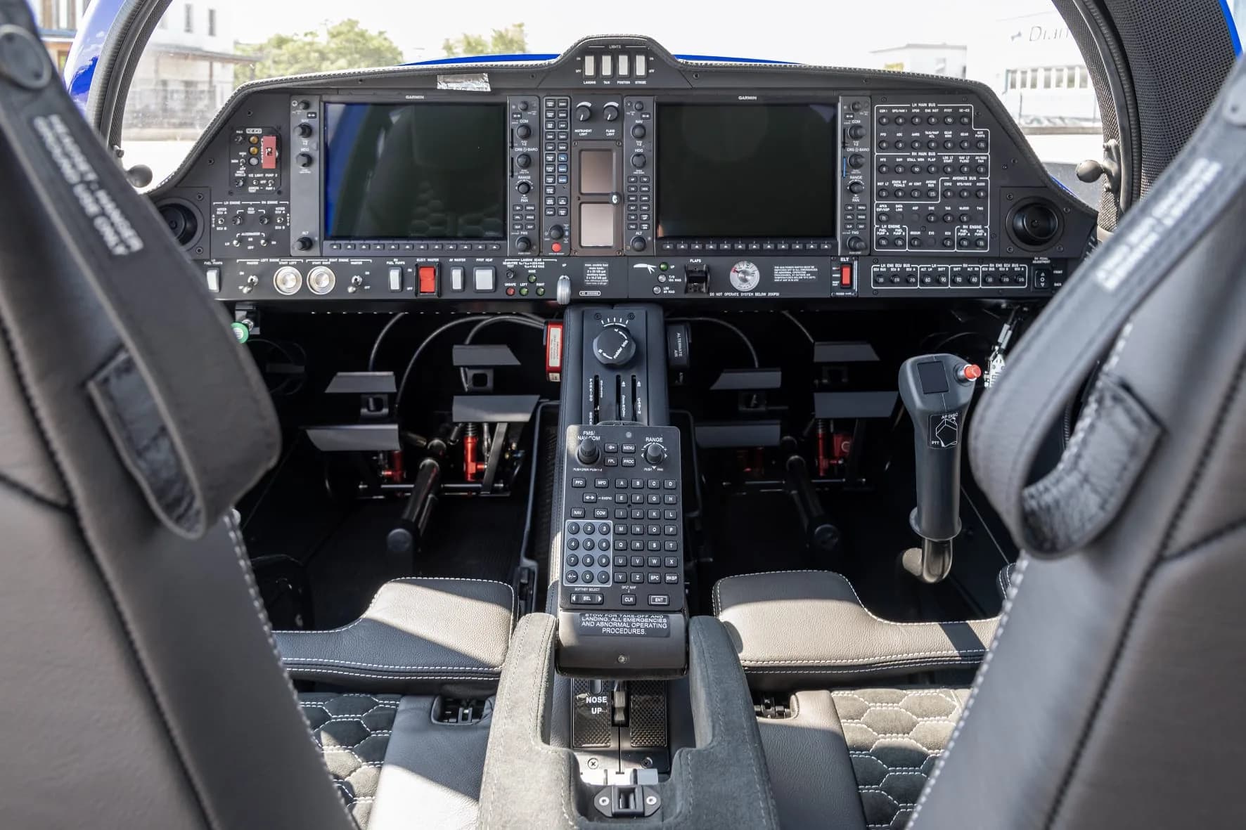 Wide view of the Diamond DA62 cockpit instrument panel and seats.