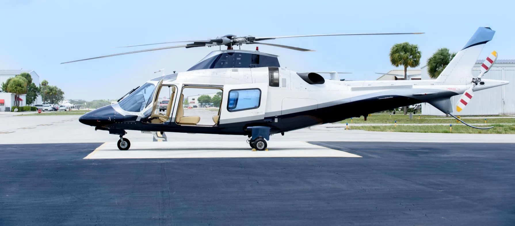 Side view of an AgustaWestland AW109 helicopter with the door open.