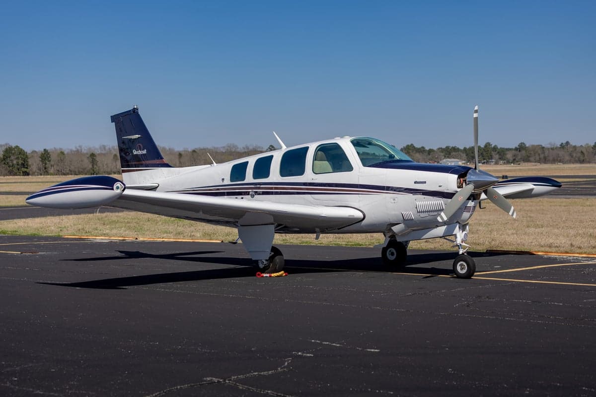 Side view of the Beechcraft Bonanza N219DK on the tarmac.