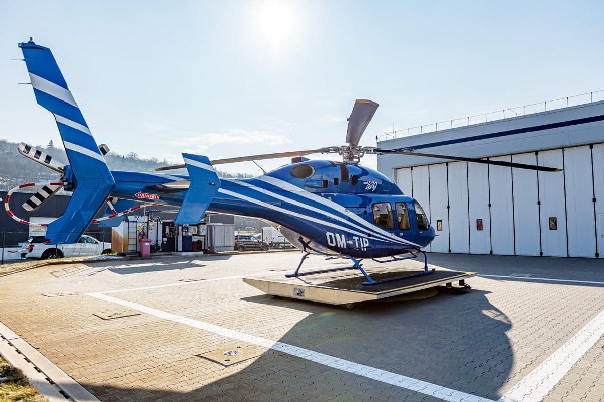 A 2012 Bell 429 helicopter with blue and white paint scheme on a platform.