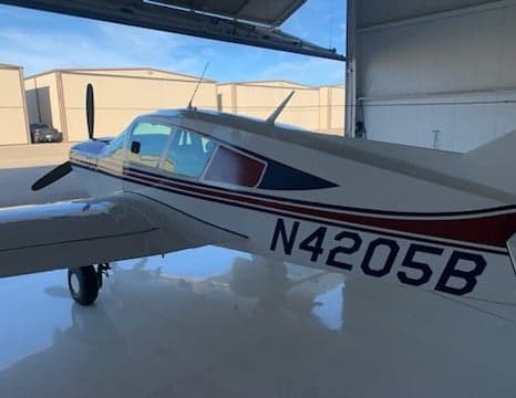 Side view of N4205B aircraft in a hangar.