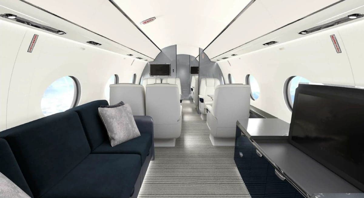 Interior view of the aircraft cabin with a sofa and seats.
