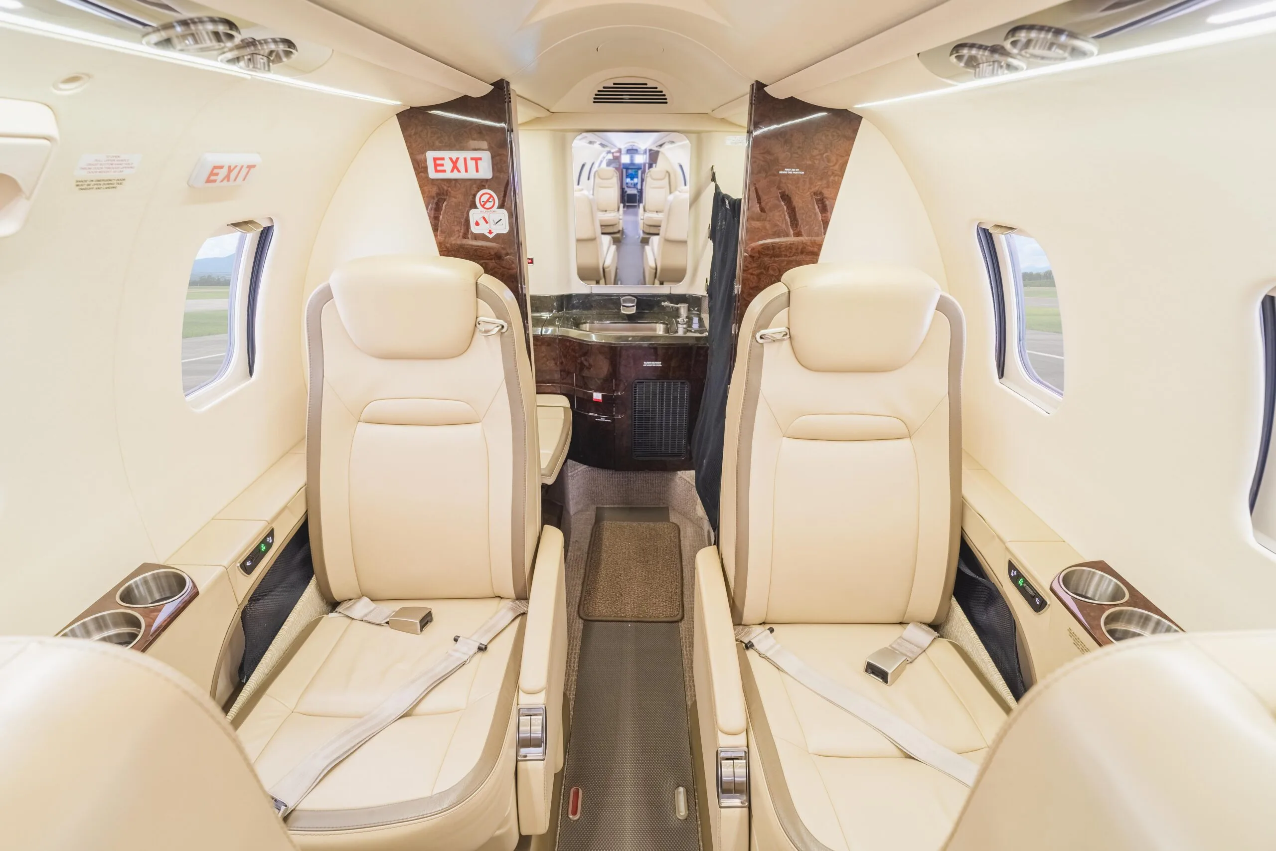 The aircraft's interior features seating and an exit sign.