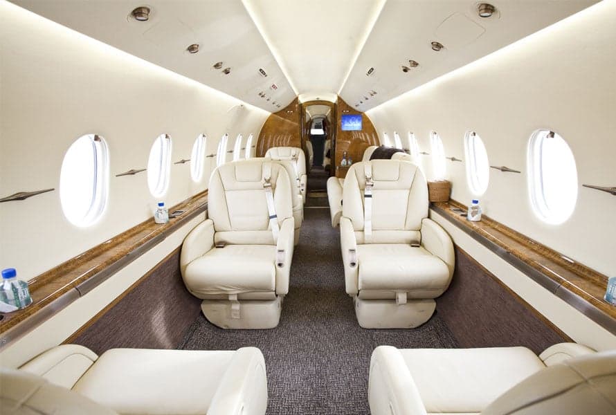 Interior view of the Hawker 4000 cabin with cream-colored leather seats.