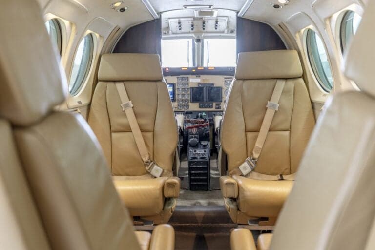 The cockpit of a King Air aircraft with dual controls and instrument panels.