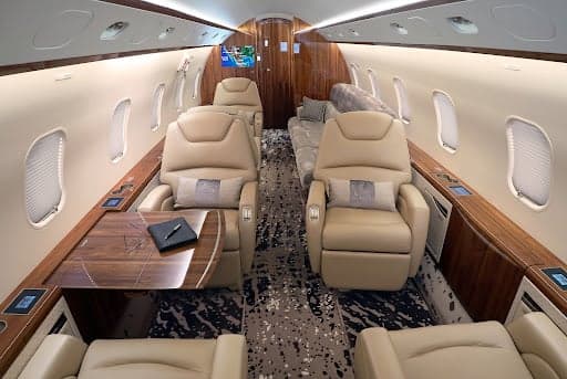 A Challenger 300 aircraft with the stairs down and door open.