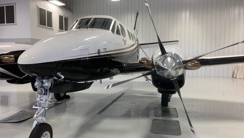 Close-up of the aircraft's nose, showing the propeller and landing gear.