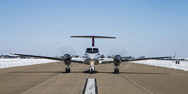 Front view of a King Air 350 on the runway, ready for takeoff.