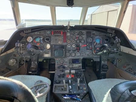 Full view of the aircraft cockpit with instrument panel and controls.