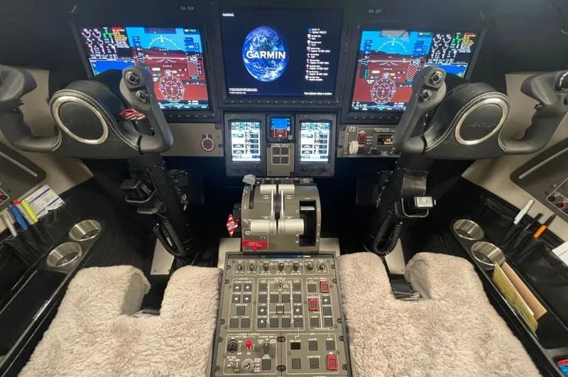 View of the aircraft cockpit with Garmin displays and controls.
