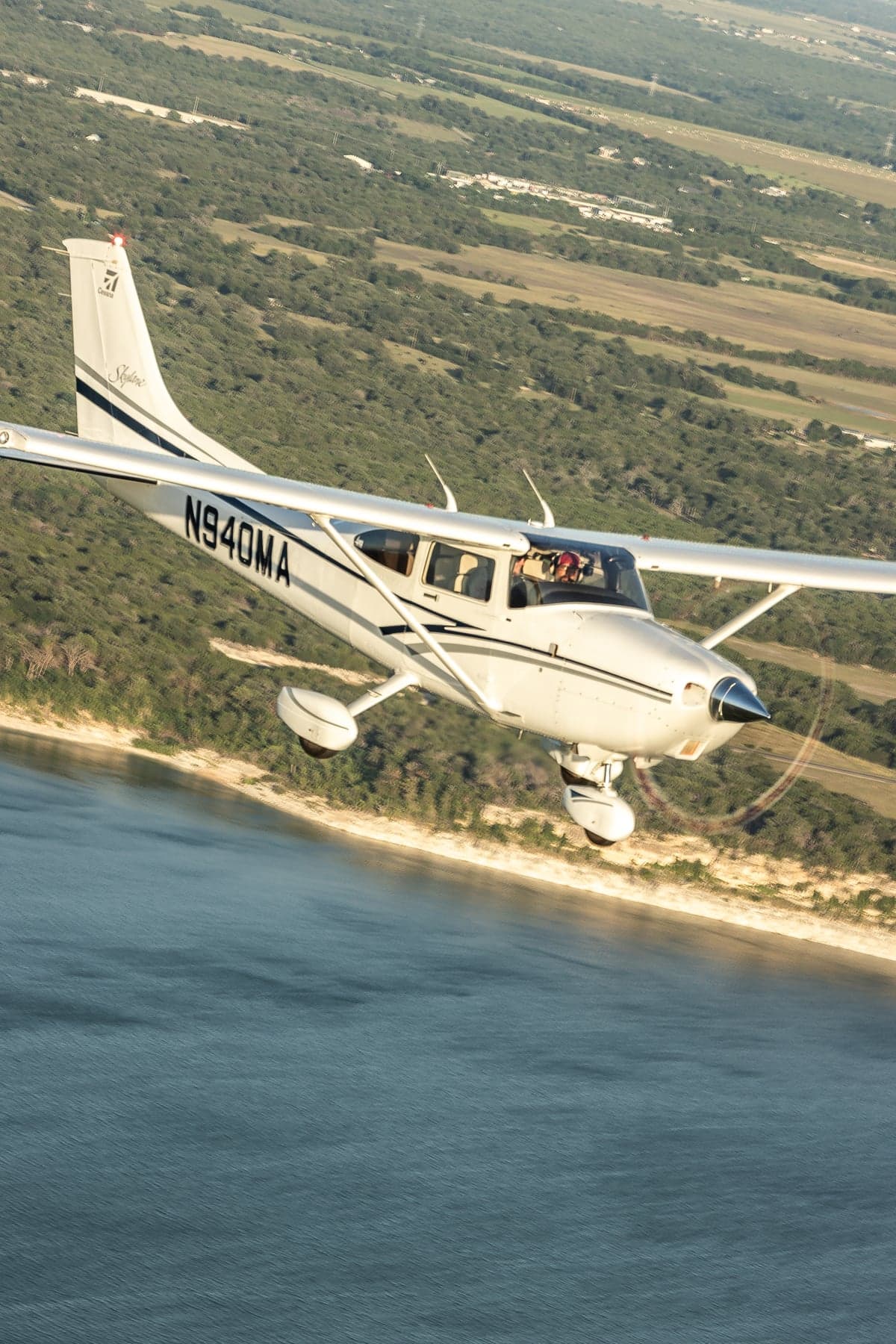 N940MA Cessna Skylane flying over water.