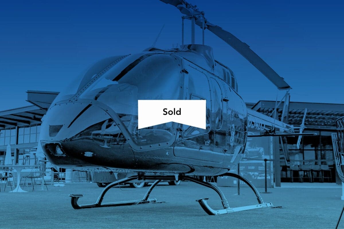 A helicopter on display with a 'Sold' banner overlaid.