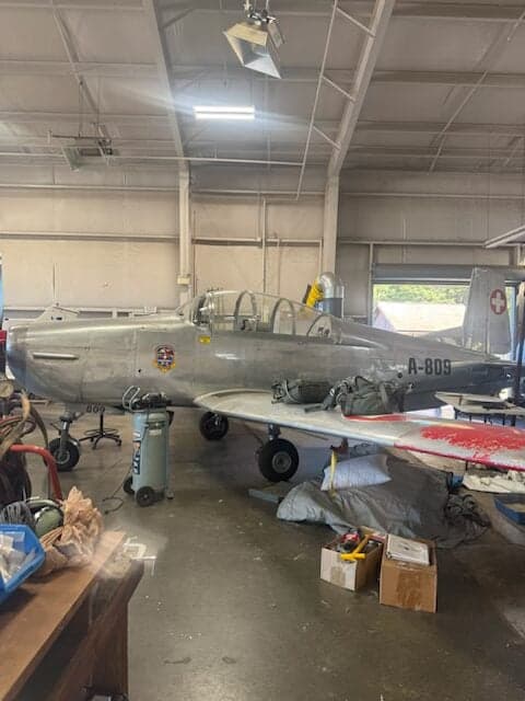A Pilatus P-3 aircraft is parked in a hangar.