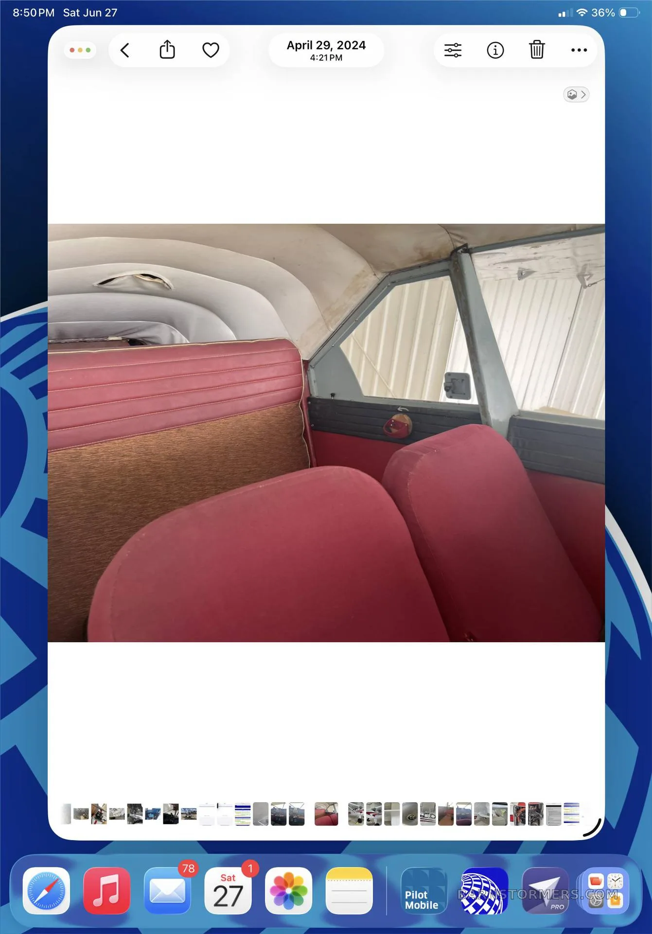 The red and brown upholstered rear seats of a small aircraft cabin.