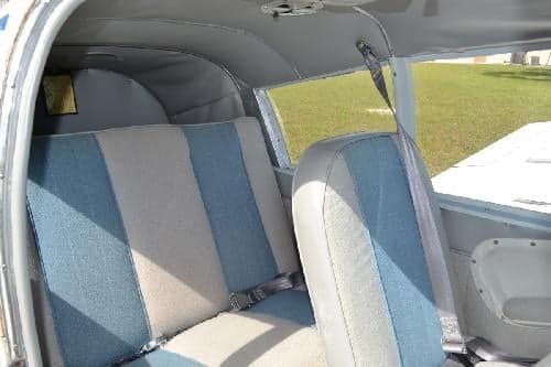 The interior of the aircraft features blue and gray striped seats.