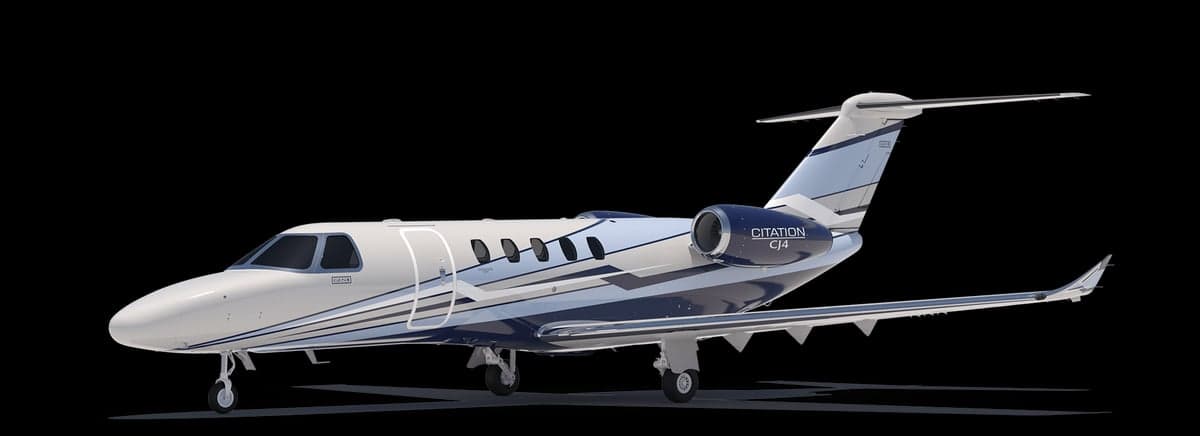 A blue and white Citation CJ4 jet on a black background.
