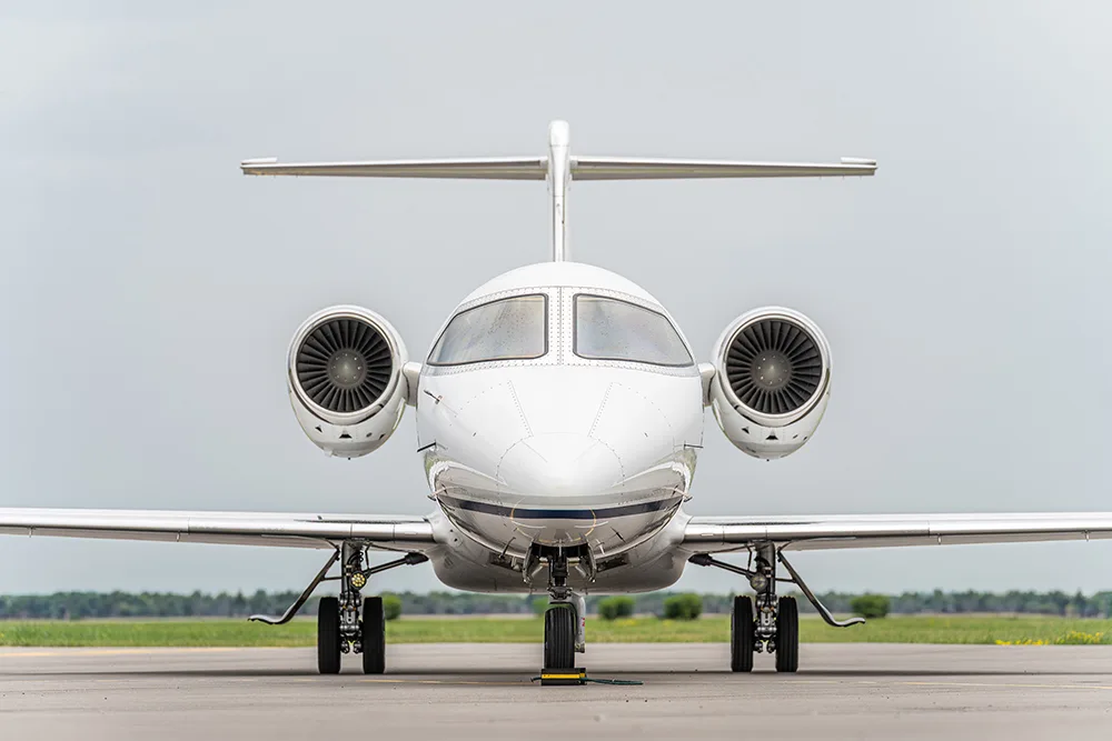 A head-on view of a white Cessna Citation business jet on a tarmac.