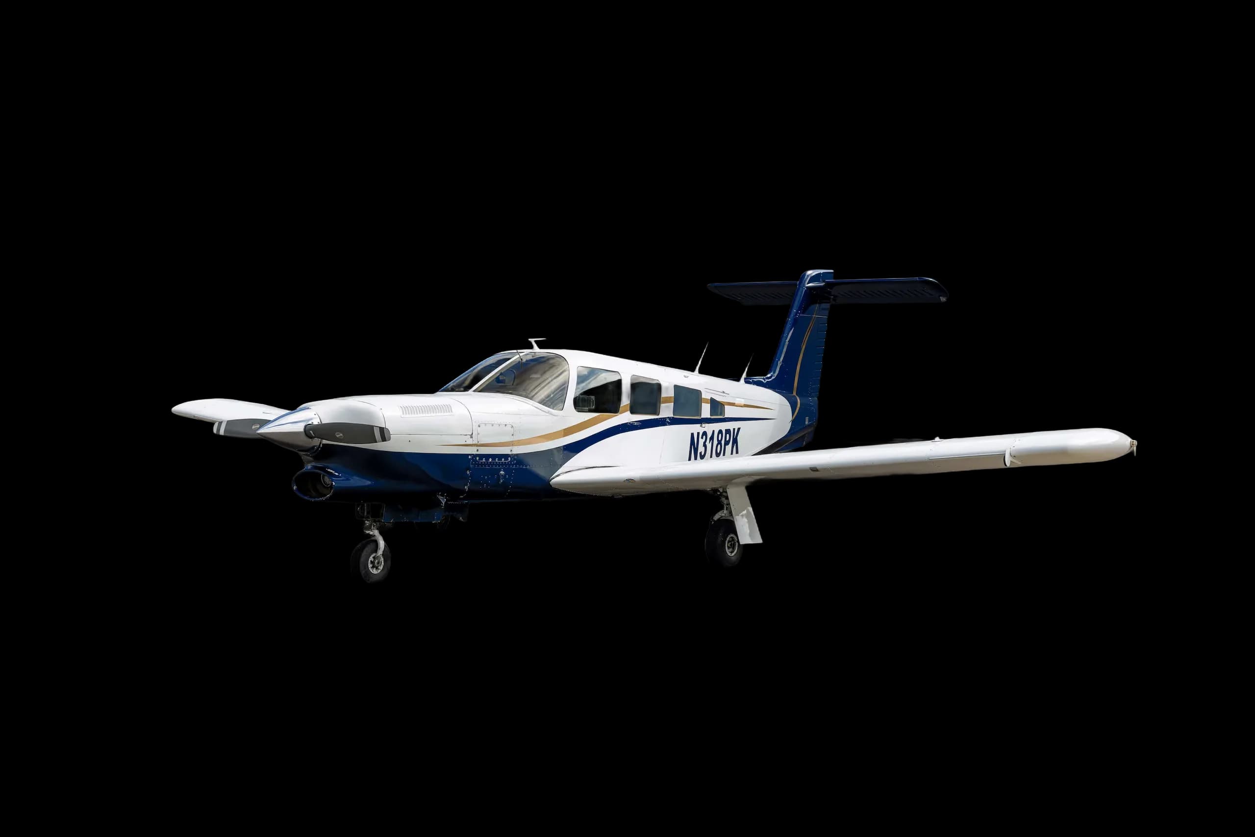A white and blue twin-engine propeller aircraft with gold stripes, registration N318PK, viewed from the front-right.