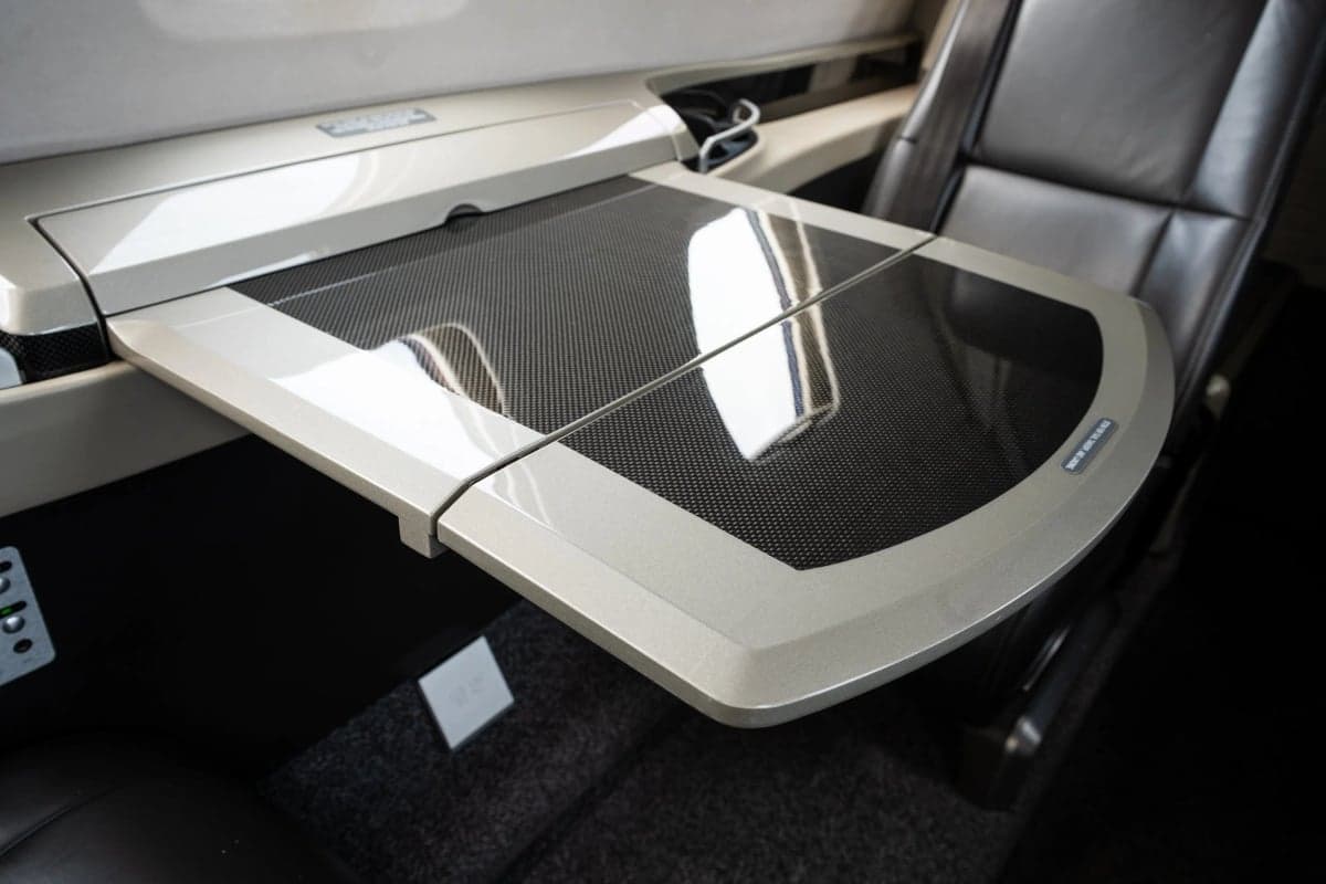 Close-up of a fold-out table in the aircraft's cabin.