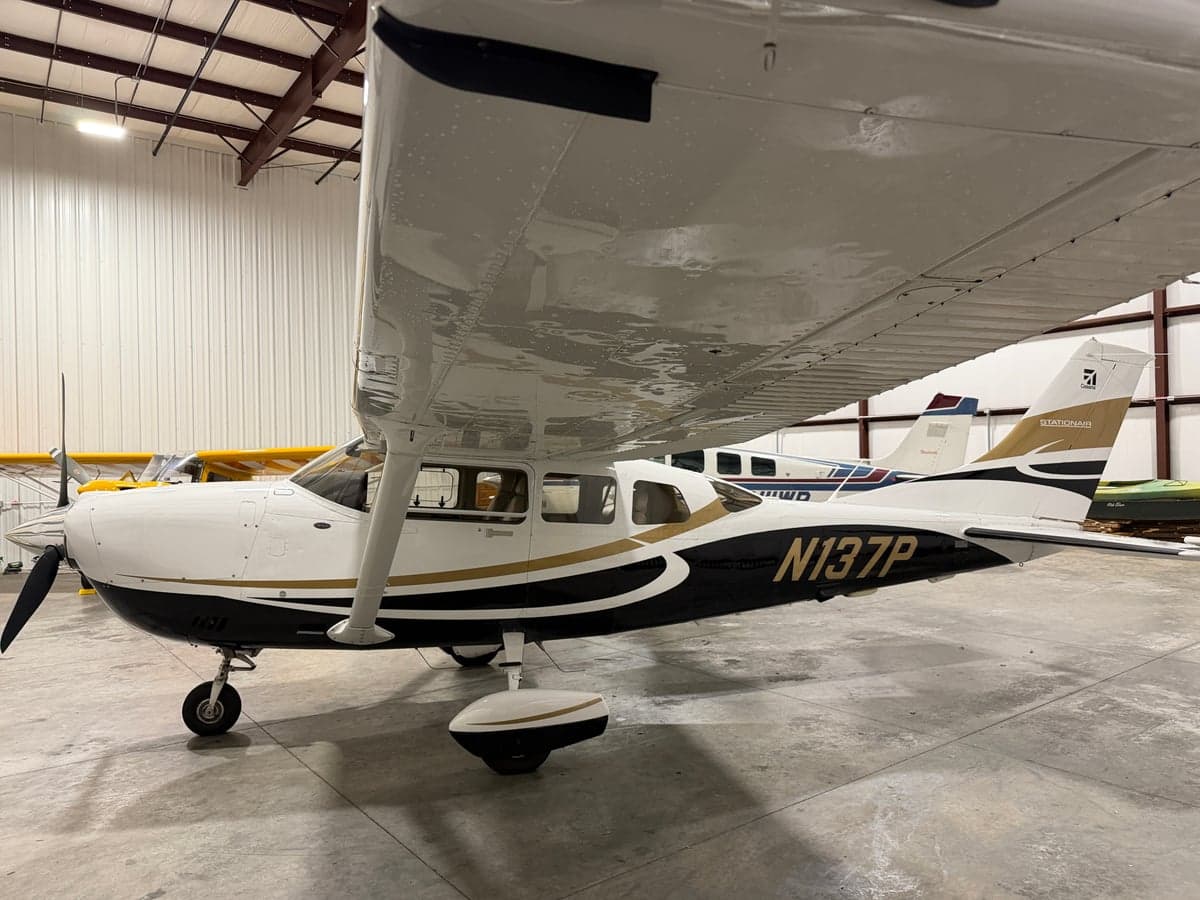 Side view of the aircraft N137P in a hangar.