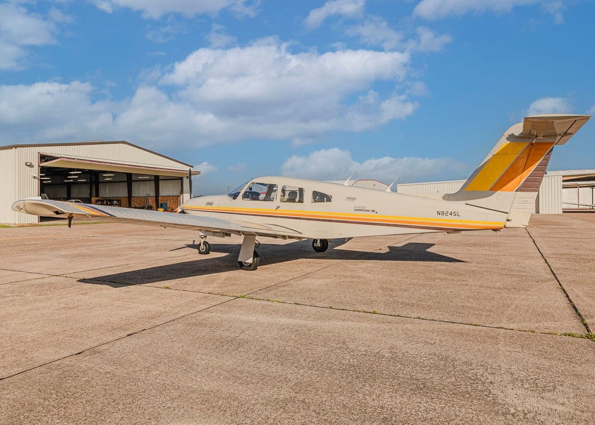 Piper Arrow II with N8245L tail number parked on the tarmac.