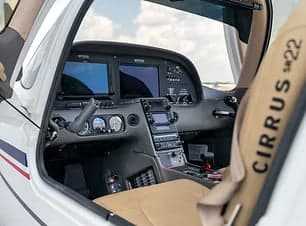 The cockpit of a Cirrus SR22 aircraft with modern avionics.