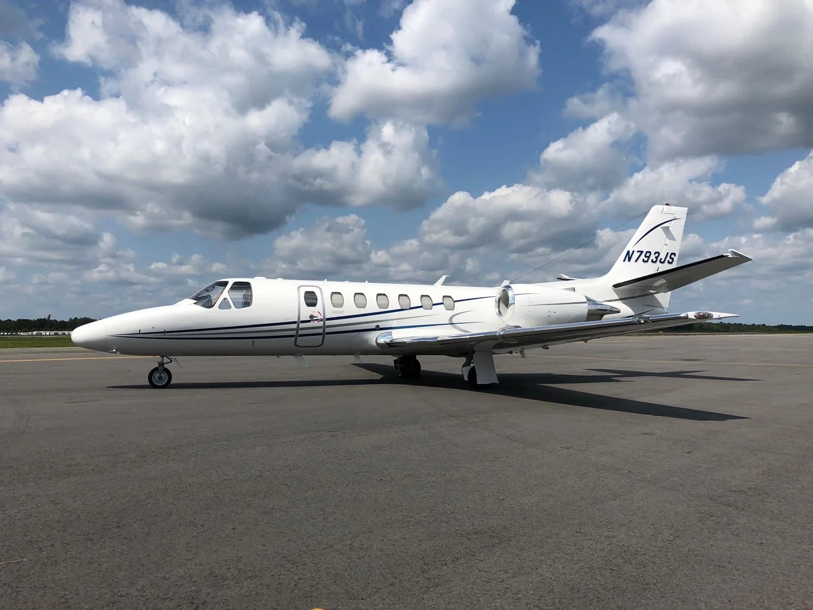 Side view of a white Citation Encore+ aircraft on the tarmac.