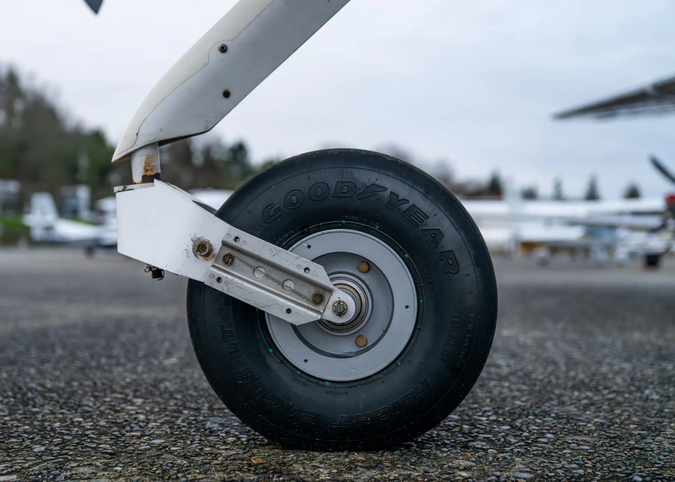 A close-up view of the main landing gear wheel of the Cirrus SR22 aircraft.