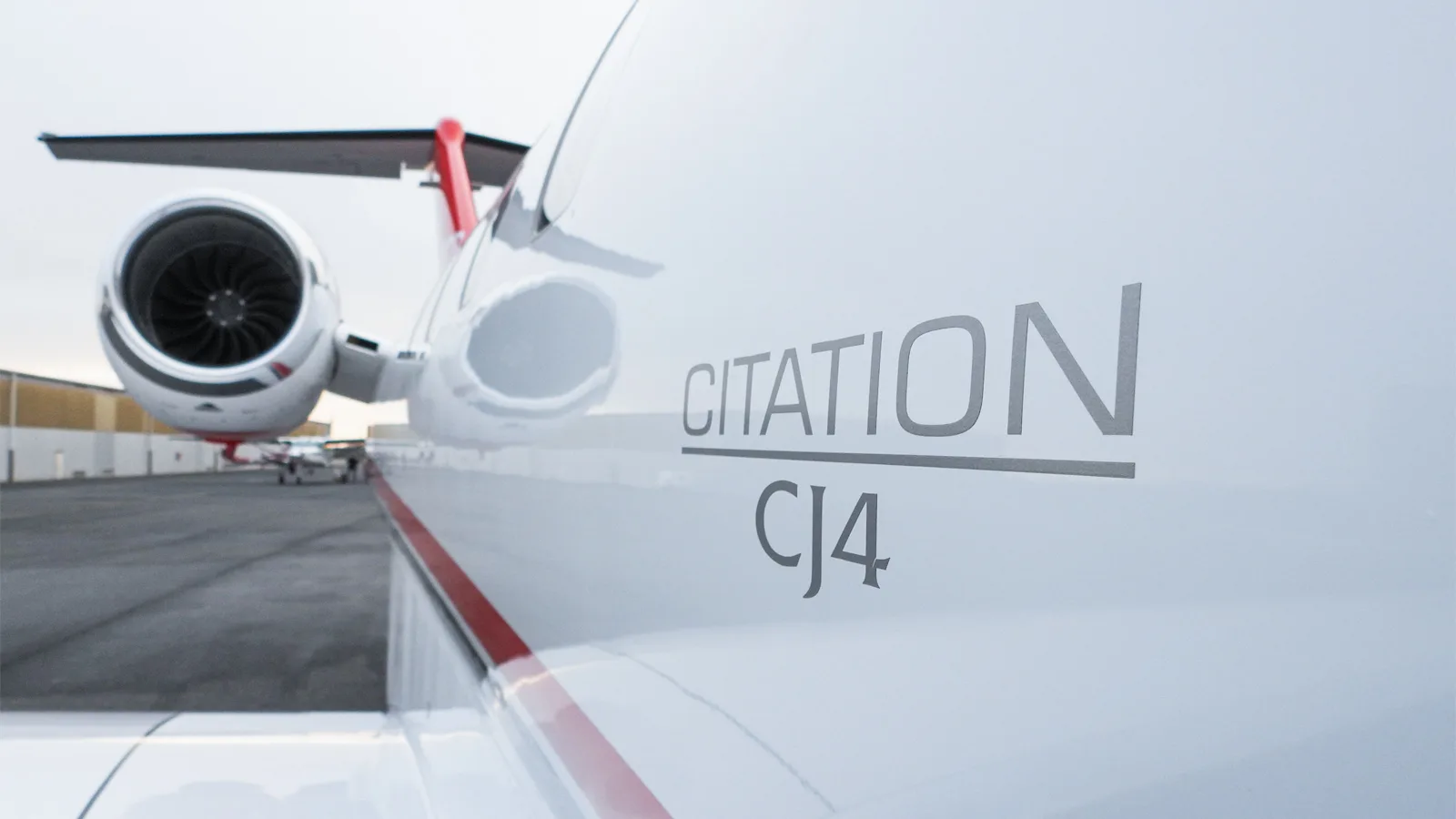 A close-up, angled view of the fuselage of a Citation CJ4 business jet, highlighting the "CITATION CJ4" text.