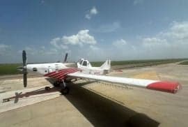 An Air Tractor crop duster sits on a runway.