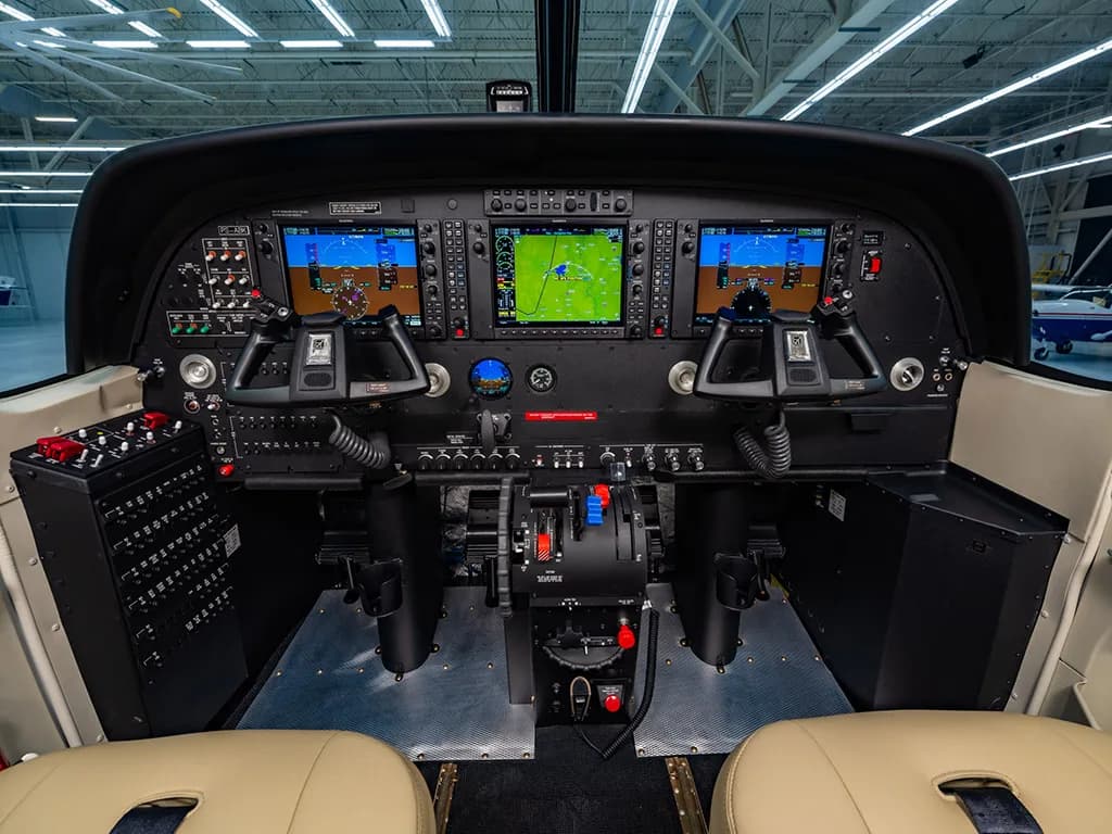 The cockpit of the aircraft, displaying a modern instrument panel with multiple digital screens and controls.