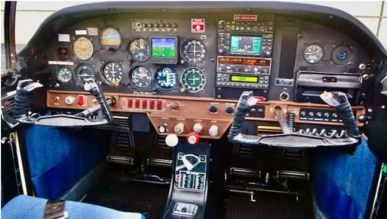 The cockpit of the aircraft features a full instrument panel and control sticks.