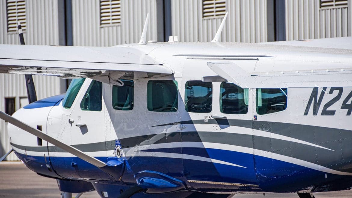 Close up of the side of a Cessna Caravan showing the paint scheme and registration number.