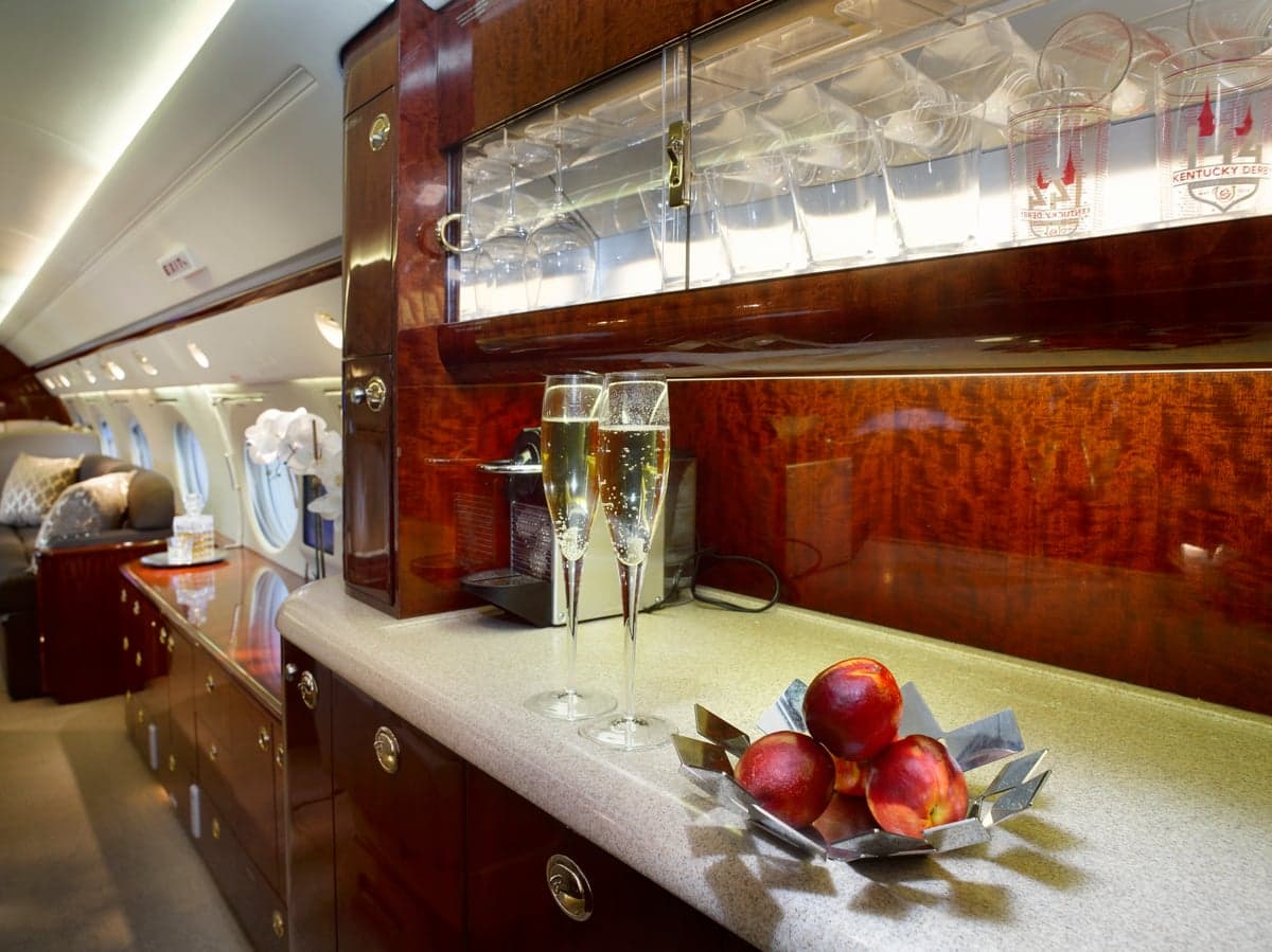 Interior view of the aircraft cabin with a bar area and fruit.