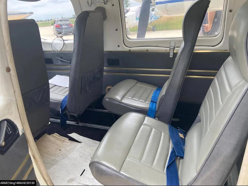 A view of the grey passenger seats and cabin interior looking towards the front of the aircraft.