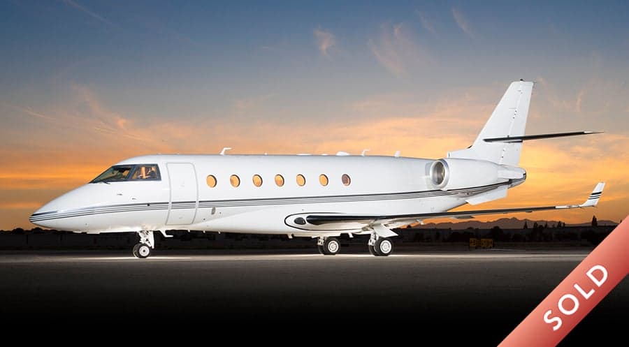 A white jet aircraft with a red 'SOLD' banner overlaid on the image.