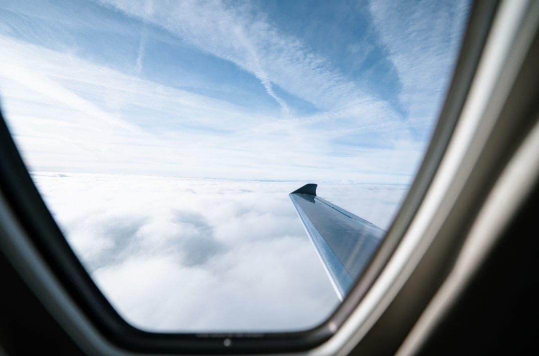 View of the wing and sky from inside the aircraft cabin.