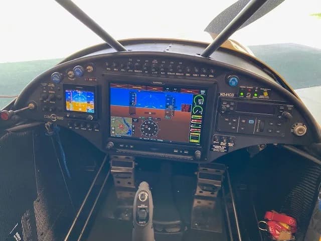 The cockpit instrument panel of the Carbon Cub with multiple digital displays and controls.