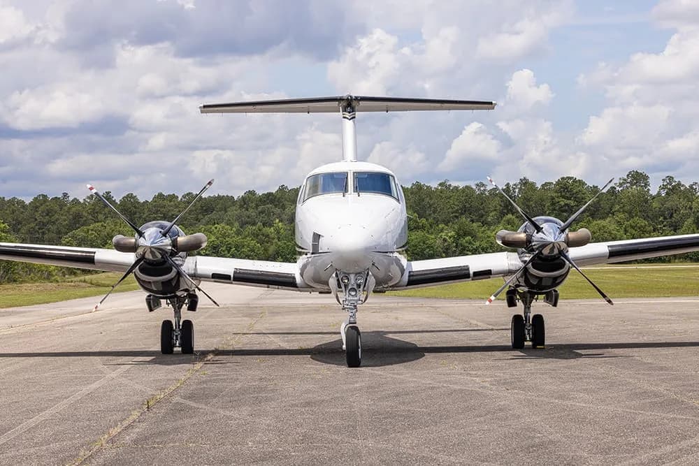 Front view of a King Air aircraft with registration N216RP on the tarmac.
