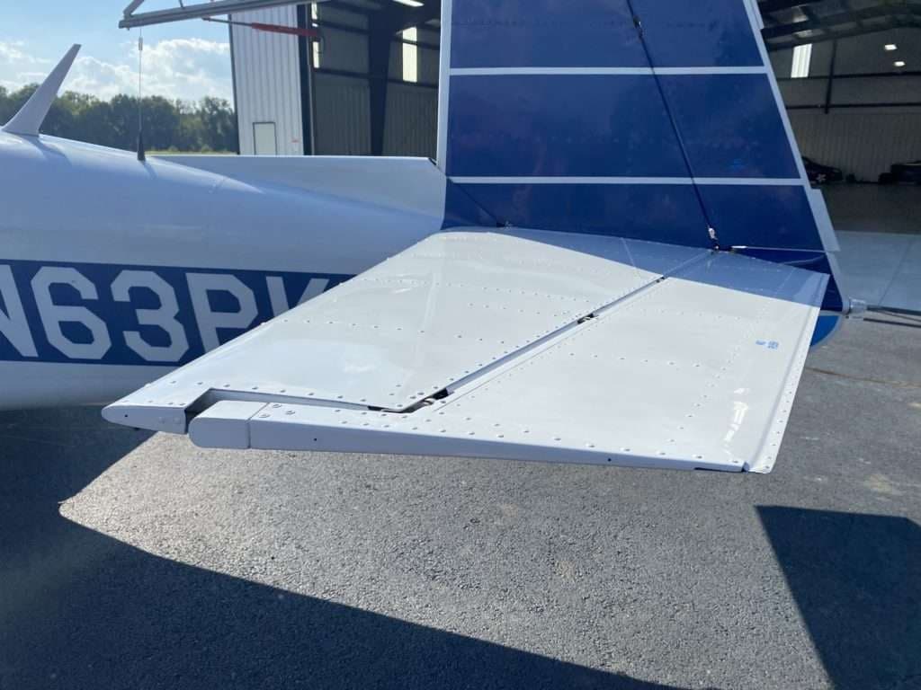 Close-up of the tail section of the Mooney M20C aircraft, showing the elevator and rudder.