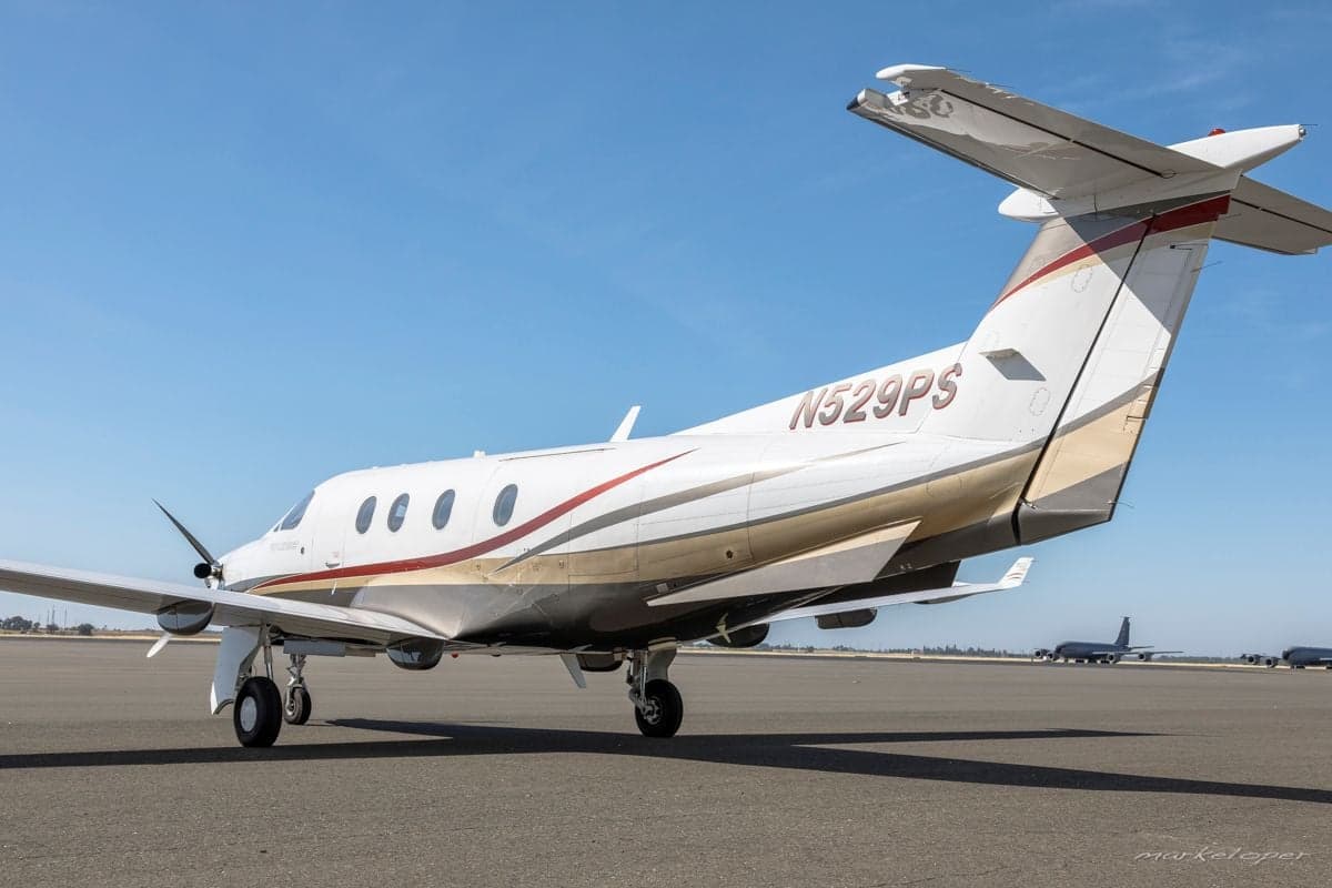 Pilatus PC-12 aircraft N529PS parked on the tarmac, rear view.
