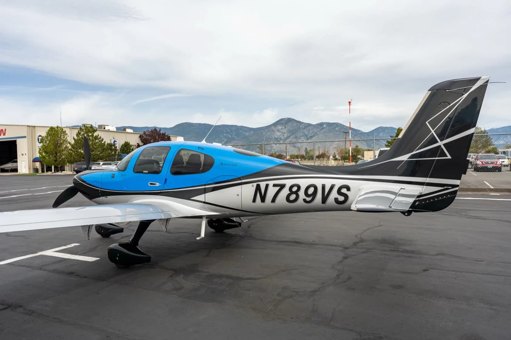 Close-up side view of the tail and fuselage of a black, blue, and silver aircraft with registration N789VS.